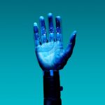 Close-up of a robotic hand showcasing advanced technology against a blue backdrop.