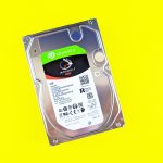 a hard drive sitting on top of a yellow surface